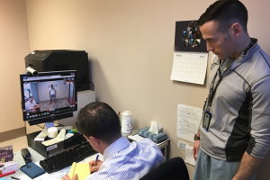 Photo of VA Provider Dr. Bradley Tucker conducting a telehealth visit with Veteran Justin "Nate" Knowles on screen at Prosthetic Innovations in Philadelphia