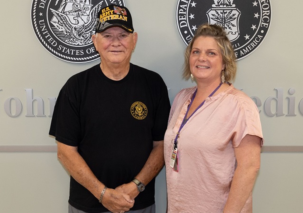 Army Veteran Robert Cutchins stands with RPM-HT Care Coordinator Kristin Moser