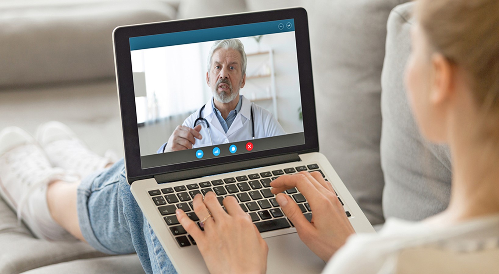 Women sits with laptop, talks with the male provider on-screen