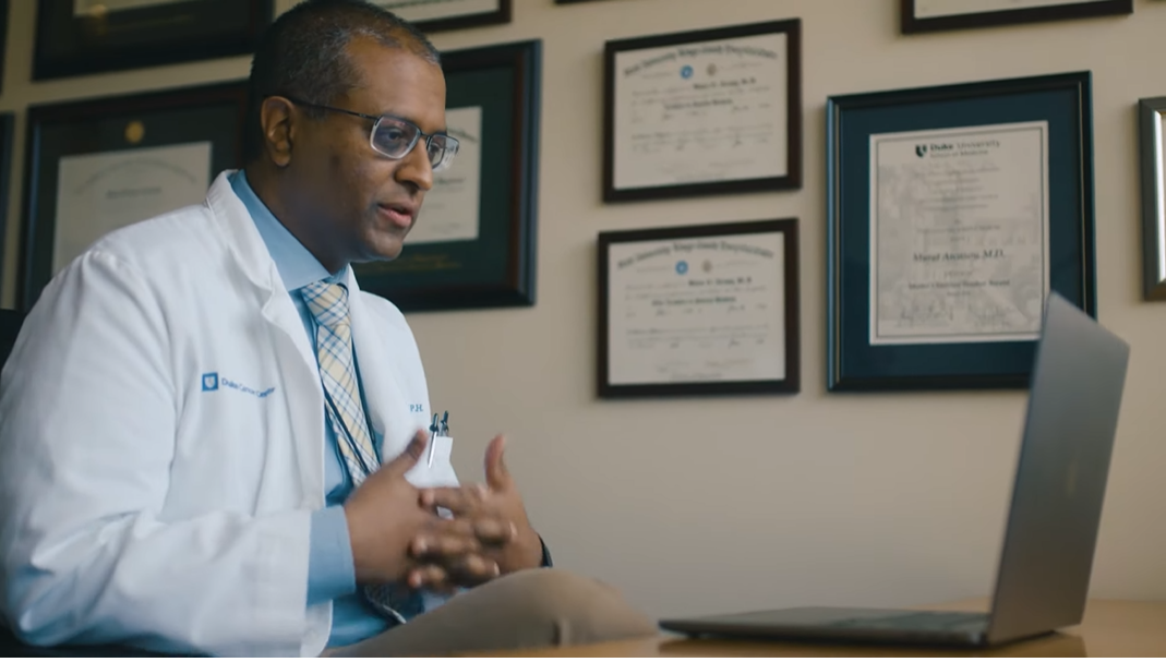 Oncology doctor speaks to patient by video