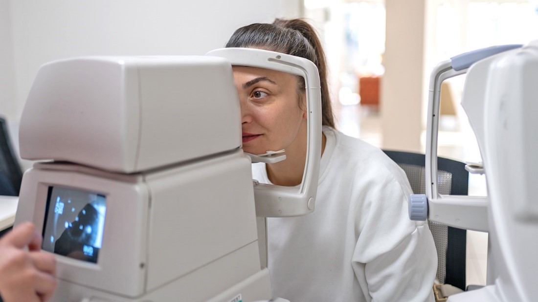 A woman taking an eye test. 