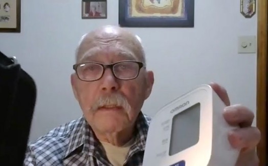 man showing his blood pressure measuring machine