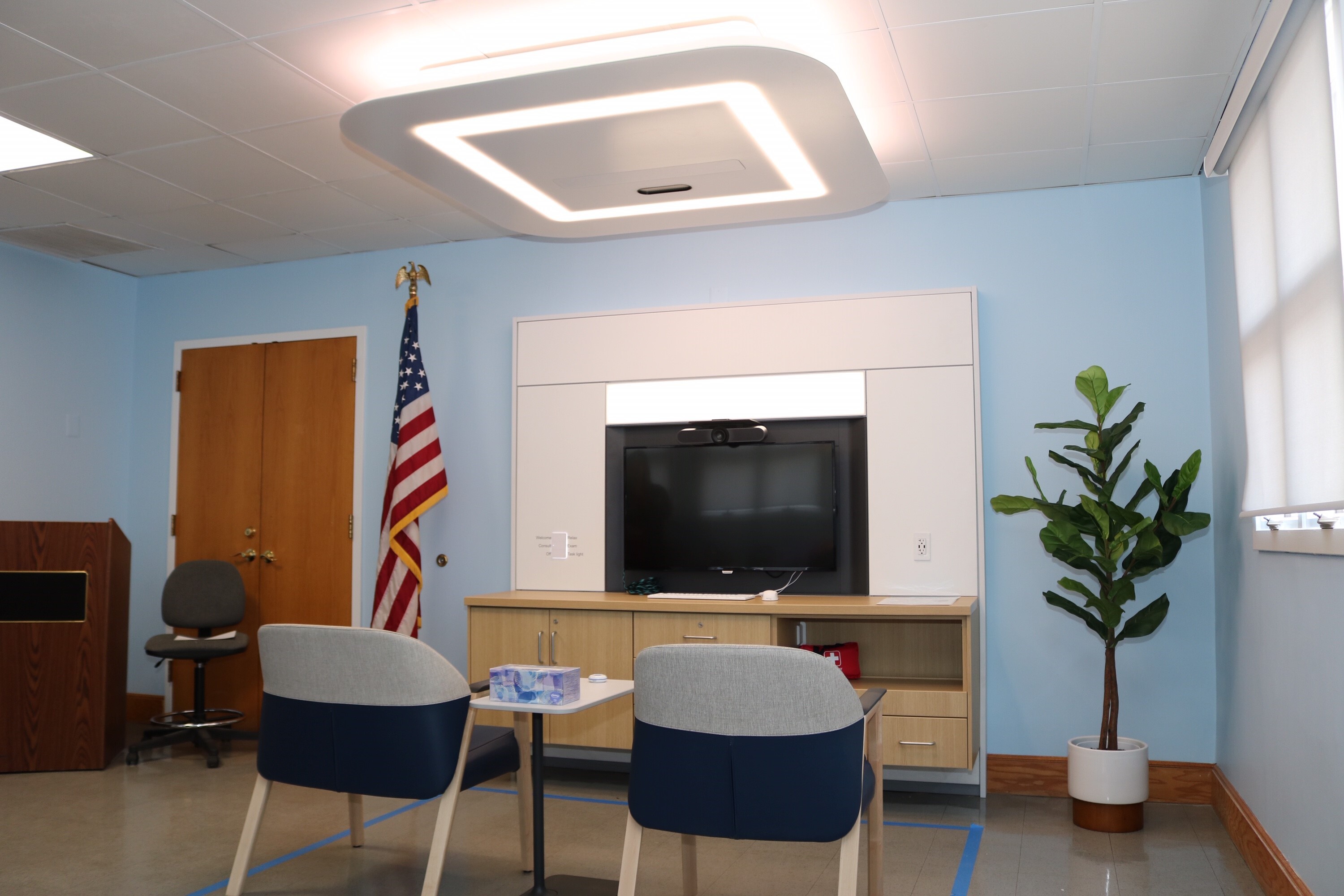 Two chairs facing a TV screen in a private appointment room