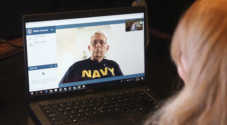 Navy Veteran on computer screen, speaking to woman provider by video 