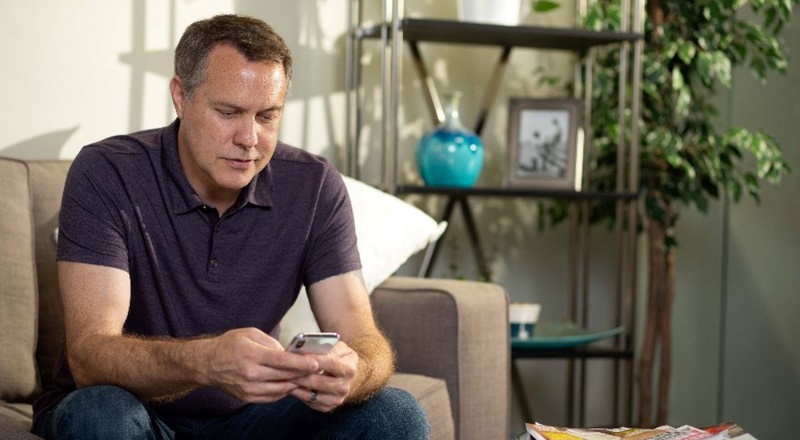 Man looks at an app on his cell phone