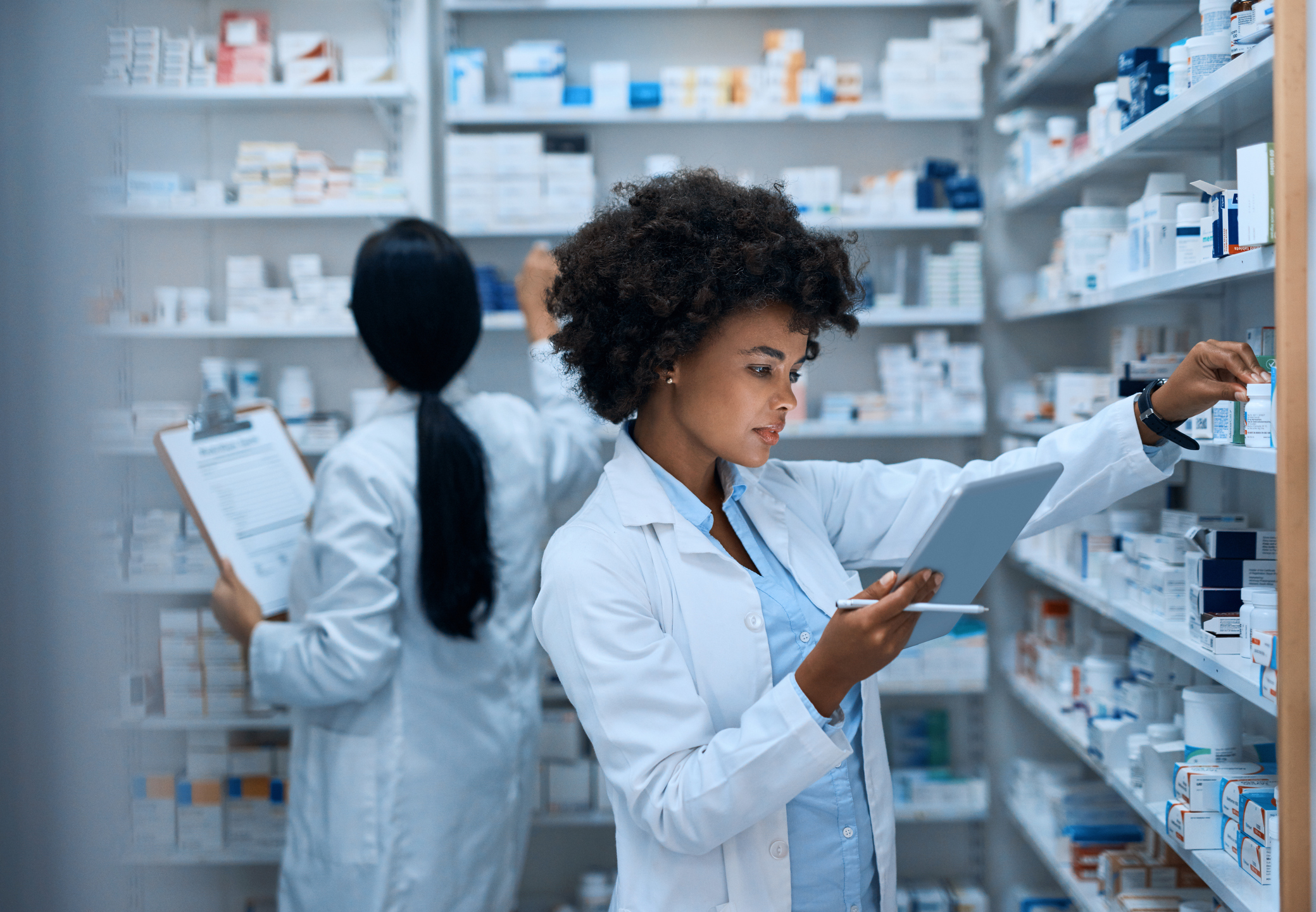 Pharmacist looking at prescriptions.