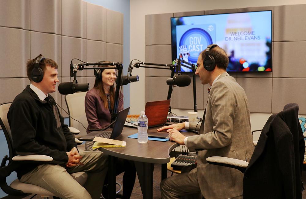 Two men and woman at a radio station