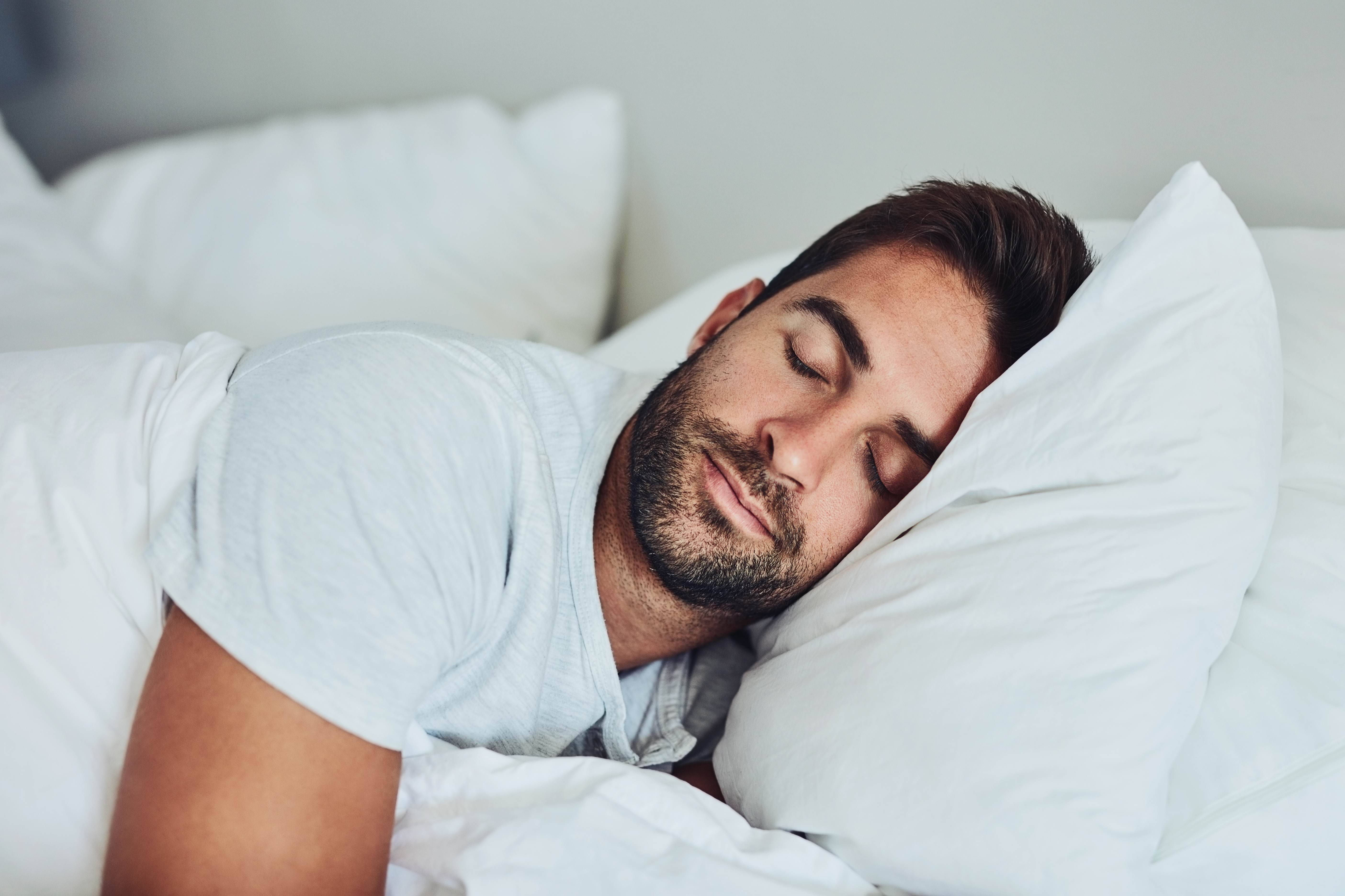 Young man sleeping in his bed