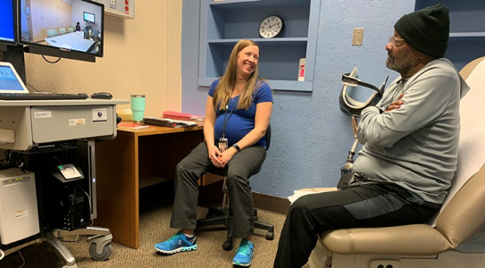 Veteran sitting in his video appointment room with clinician.