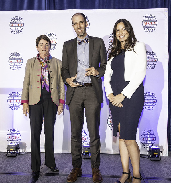 Dr. Evans of Connected Care holding an award.