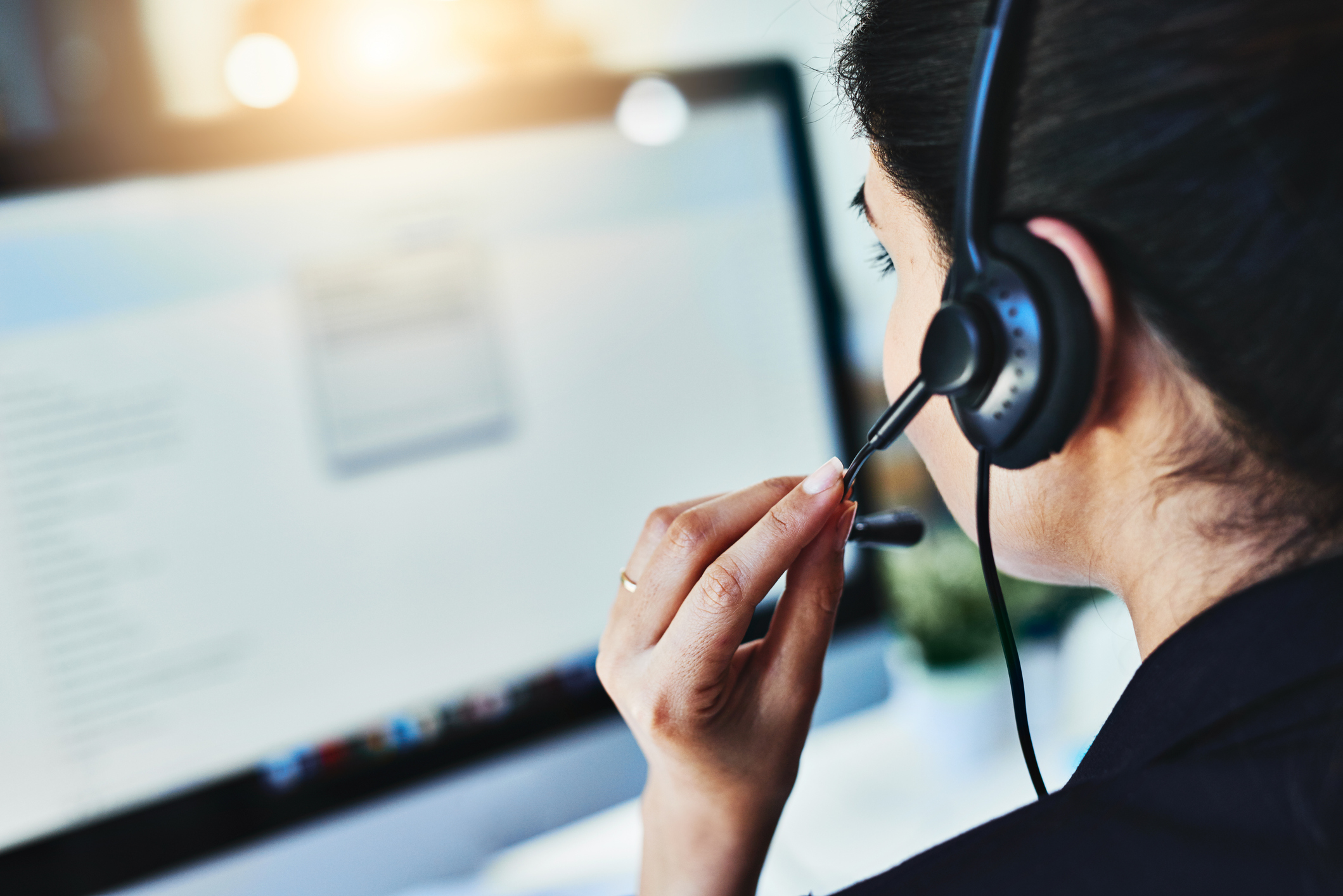 A woman using a headset to take a call.