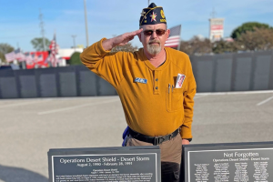 Older Veteran in yellow shirt saluting