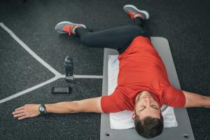 A man stretching on a yoga mat. 