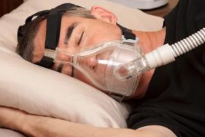 man sleeping with apnea machine