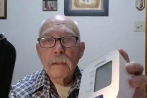 man showing his blood pressure measuring machine