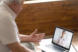Man speaks to provider face-to-face by video