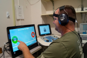 Veteran using telehealth technology for his hearing loss.