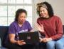 A Veteran and a caregiver joining a virtual call on a laptop. 