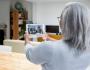 Woman uses her tablet on a virtual call to show her living room.