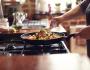 A photo of someone cooking vegetables in a pan.