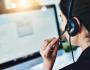 A woman using a headset to take a call.